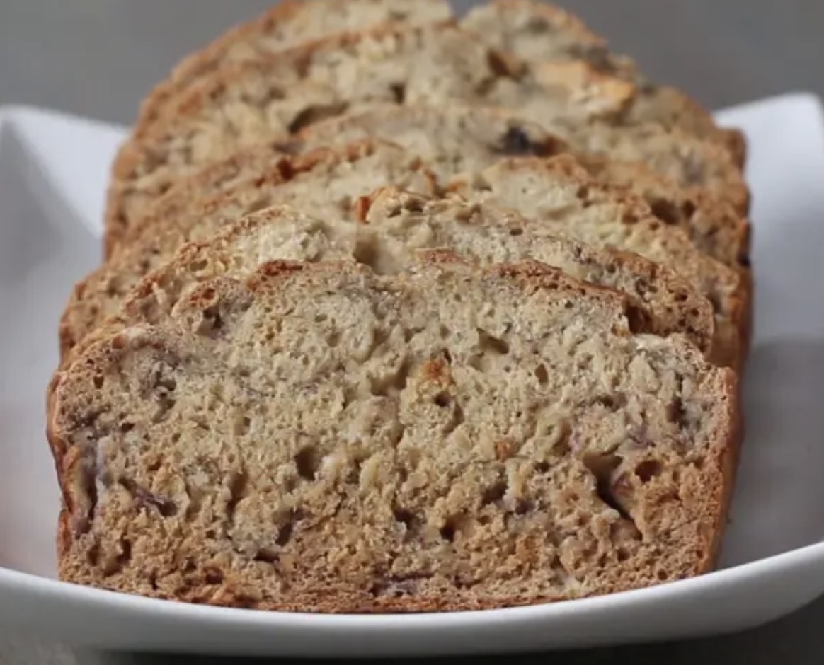 Several slices of banana bread arranged on a white plate